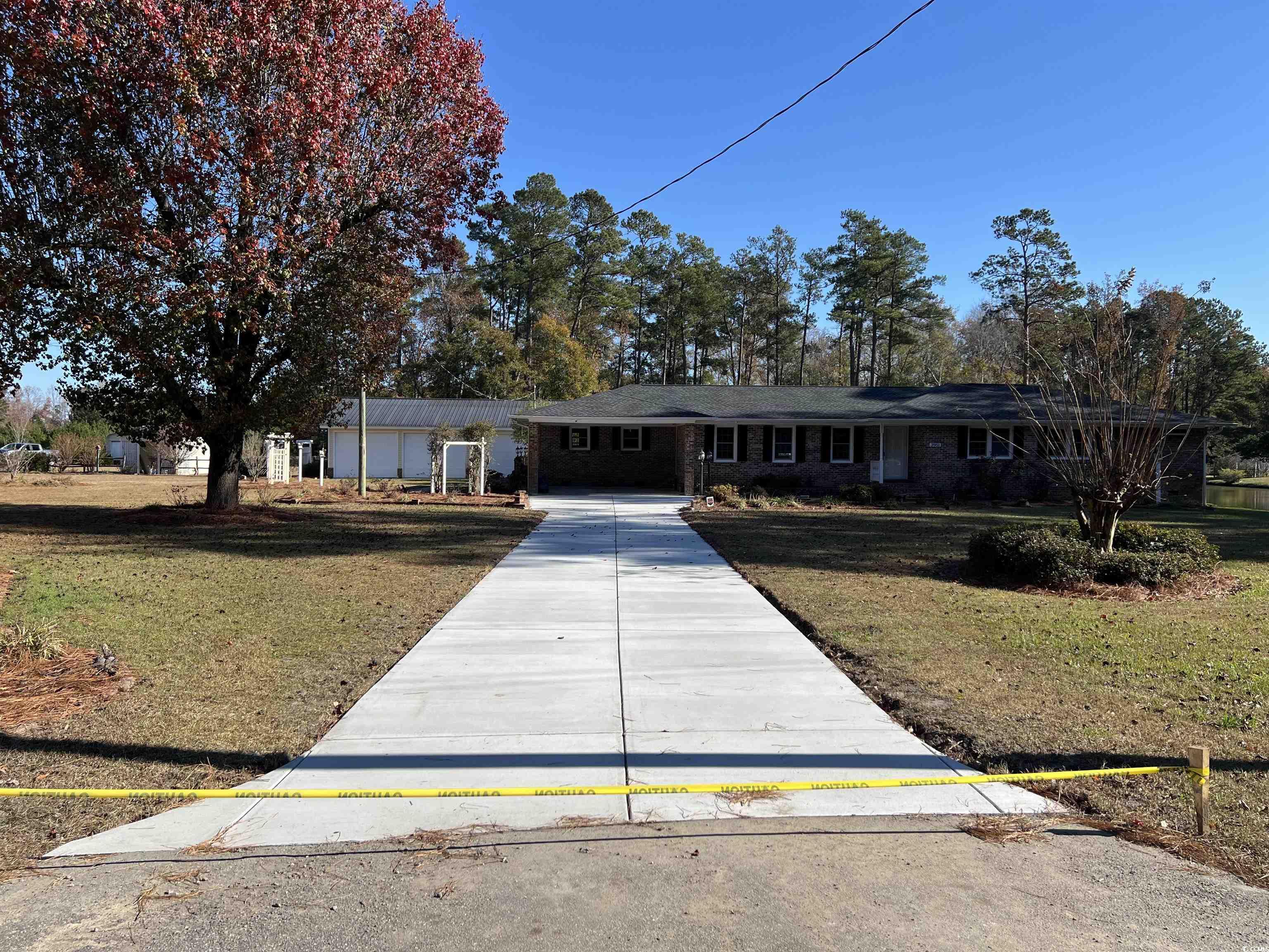 Single story home featuring a front lawn