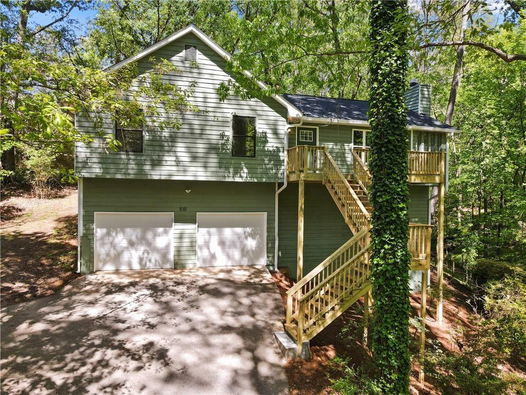 a view of house with roof deck and chair