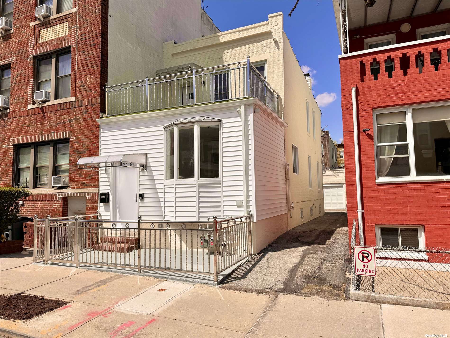 a view of a house with a small yard and wooden fence