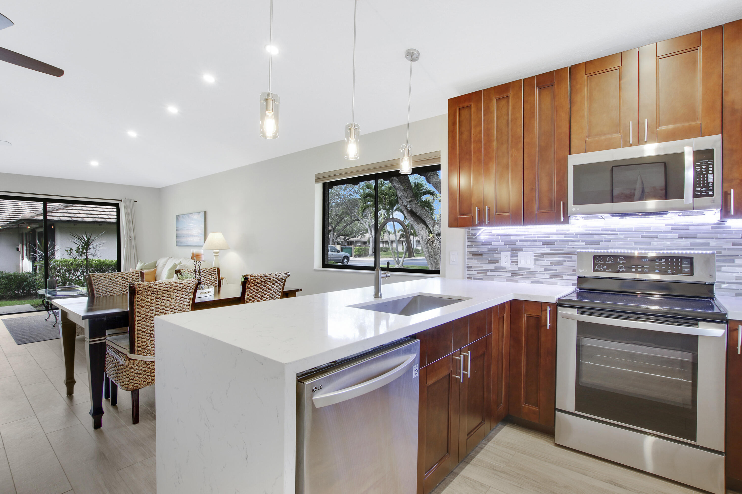 a kitchen with stainless steel appliances kitchen island granite countertop a sink stove and cabinets