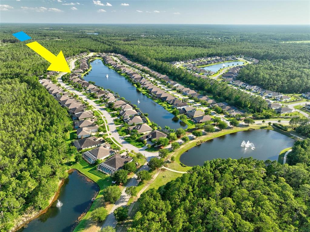 an aerial view of residential houses with outdoor space and swimming pool