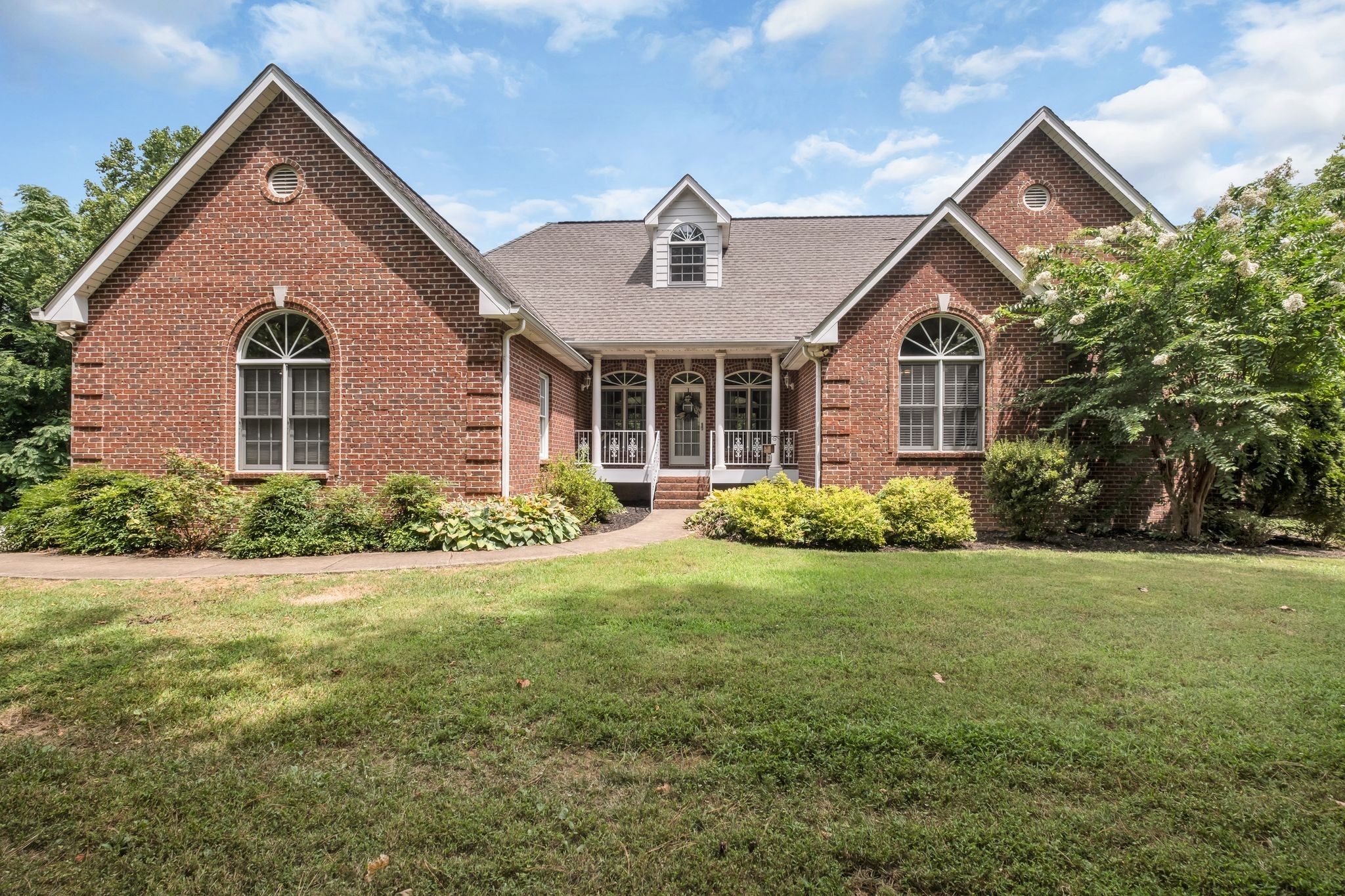 a front view of a house with a yard