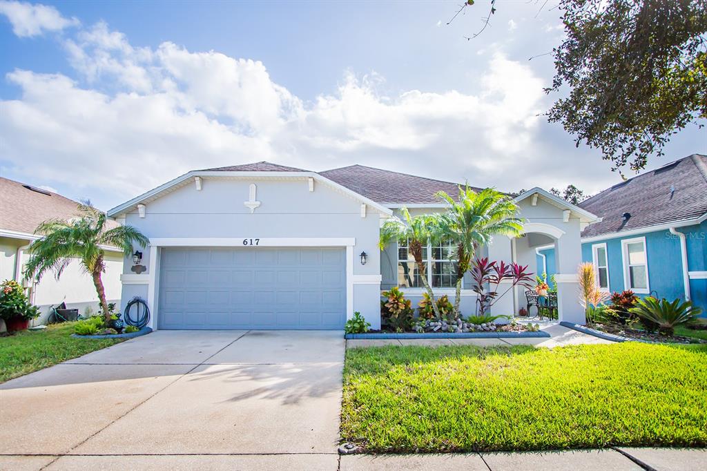 a front view of house with yard and entertaining space