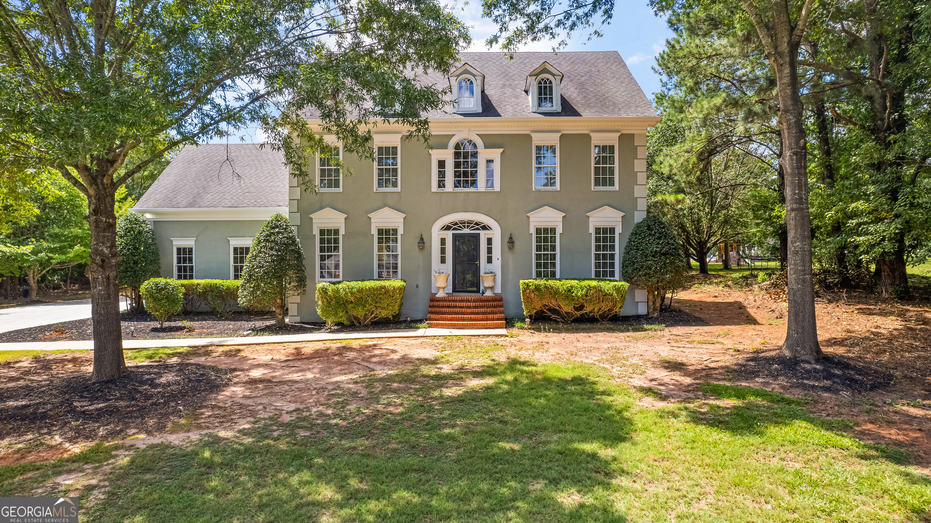 a front view of a house with a yard