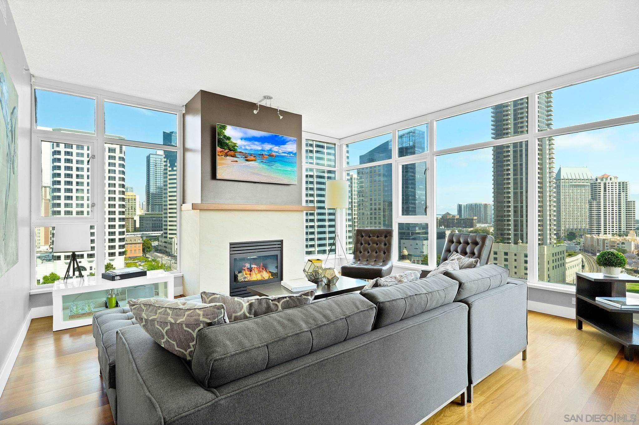 a living room with furniture fireplace and a large window