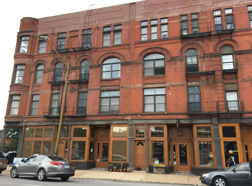 a front view of a building with a lot of windows