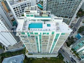 a tall building with large trees