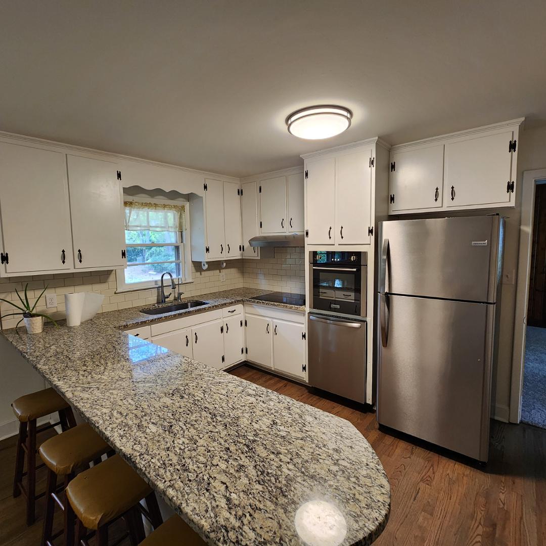 a kitchen with a refrigerator and a sink