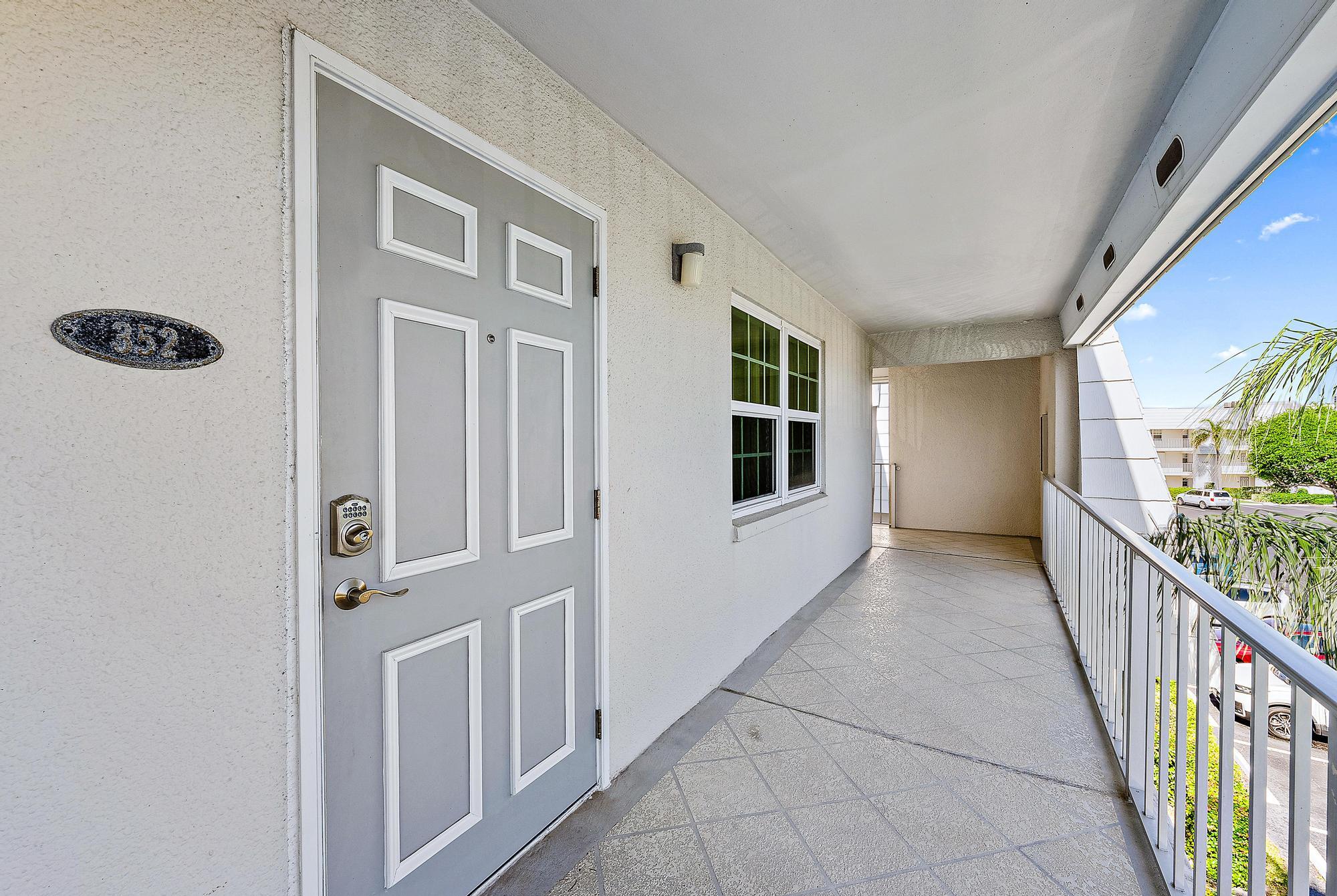 a view of a hallway with windows and stairs