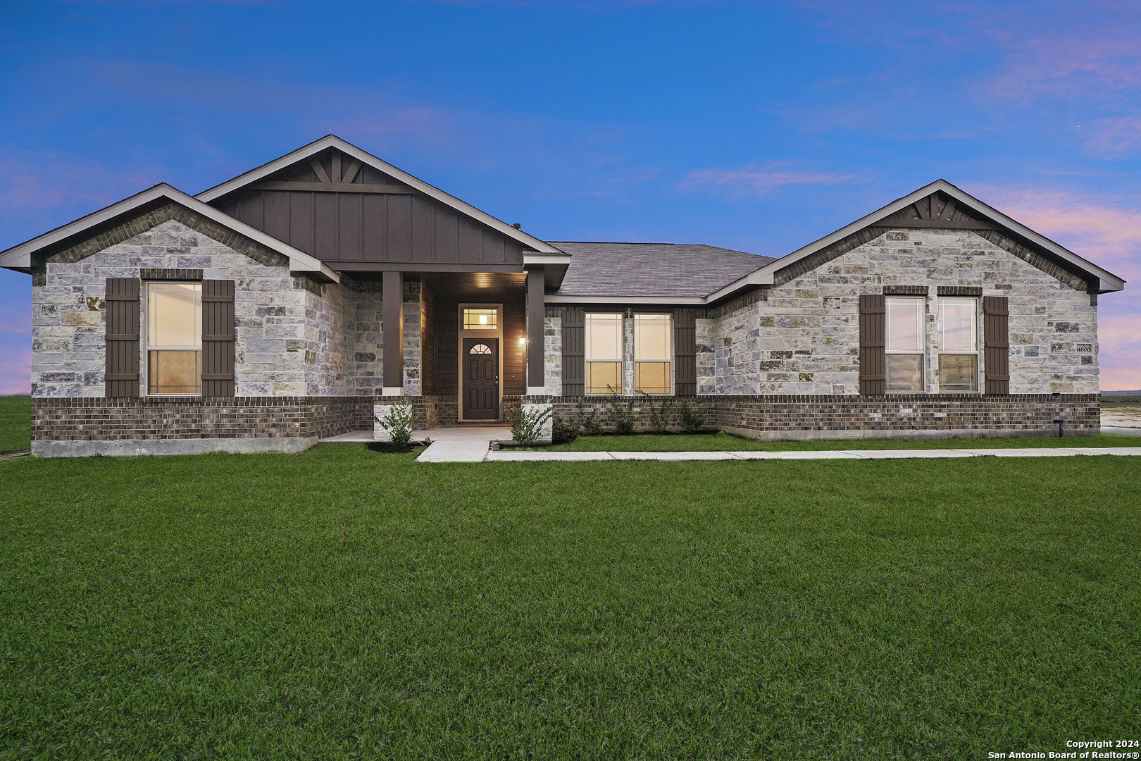 a front view of a house with a yard