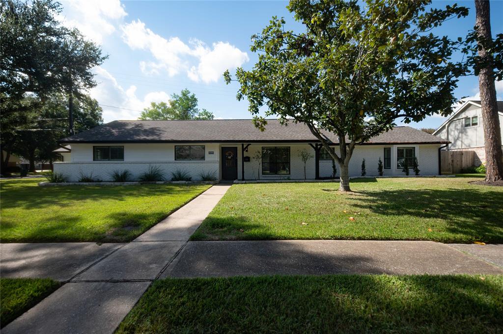 a view of house that has a yard