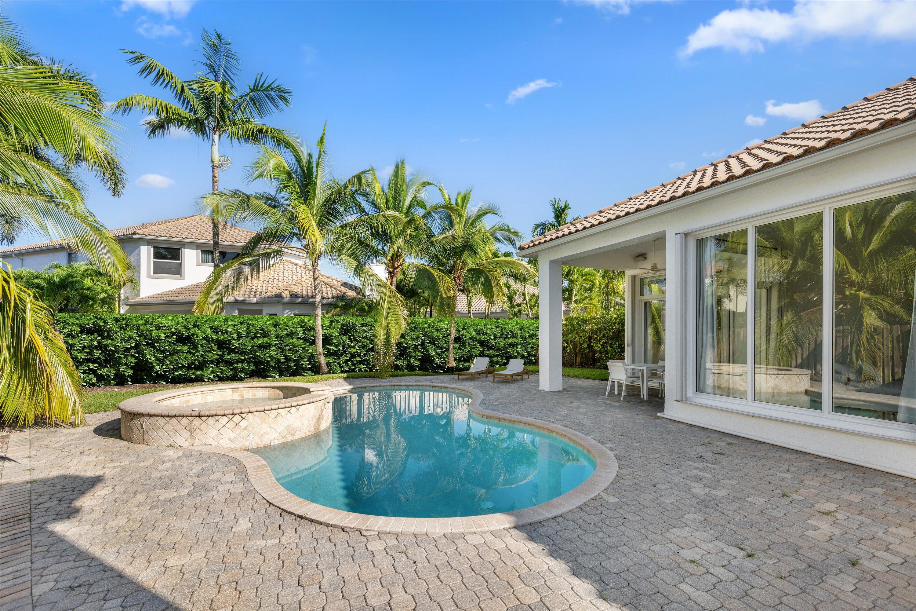 a view of a house with a small yard and sitting area