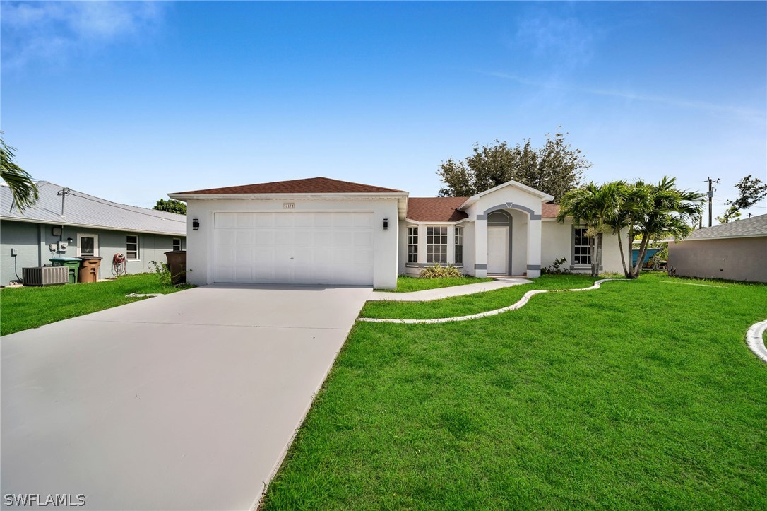 a front view of a house with a yard and garage