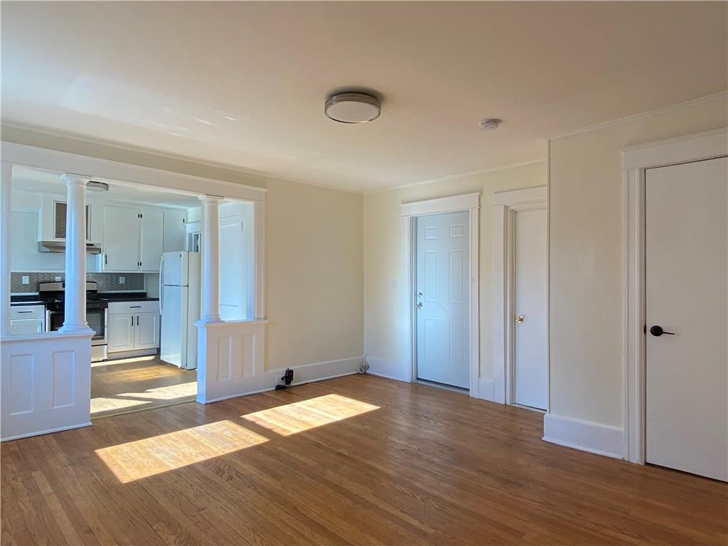 a view of empty room with wooden floor