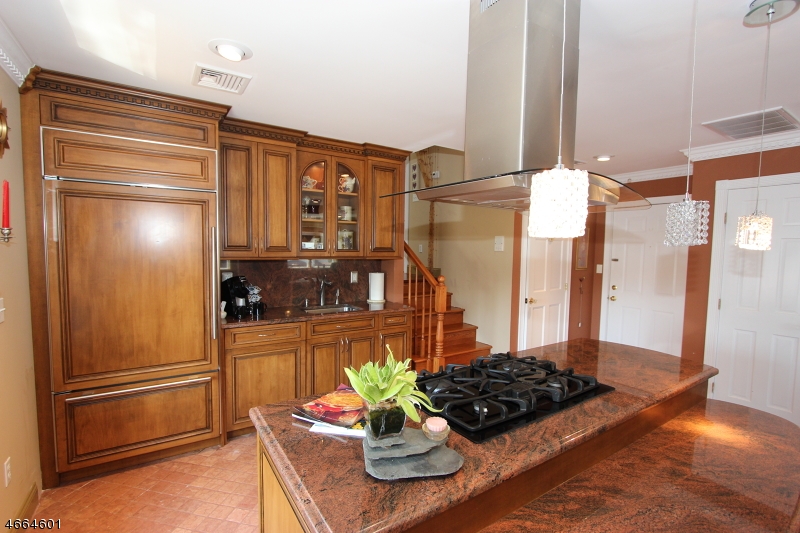 a kitchen with stainless steel appliances granite countertop a refrigerator and a stove