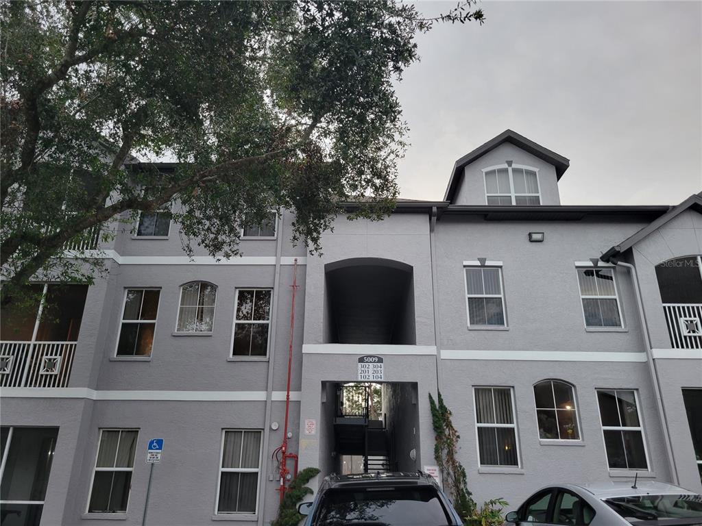 a front view of a residential apartment building with a yard