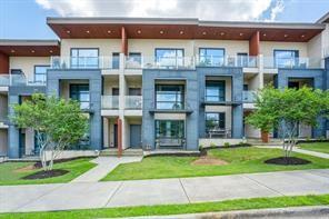 a front view of a residential apartment building with a yard