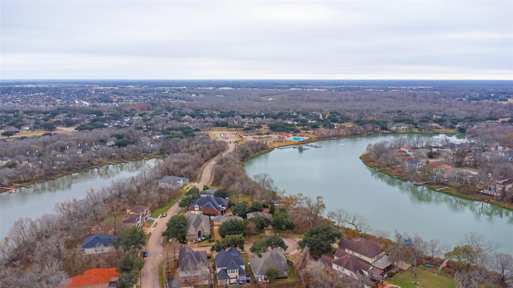 an aerial view of lake and residential houses with outdoor space