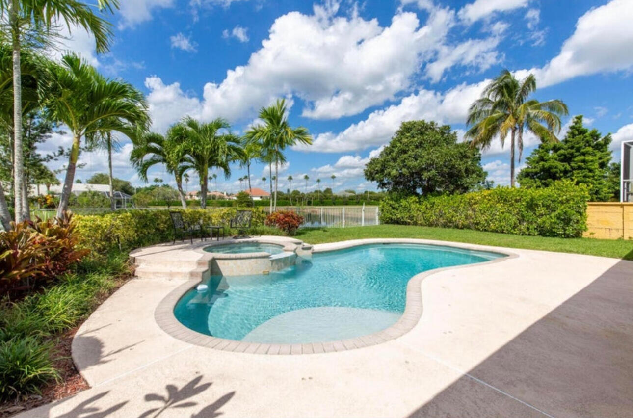 a view of a swimming pool with a yard