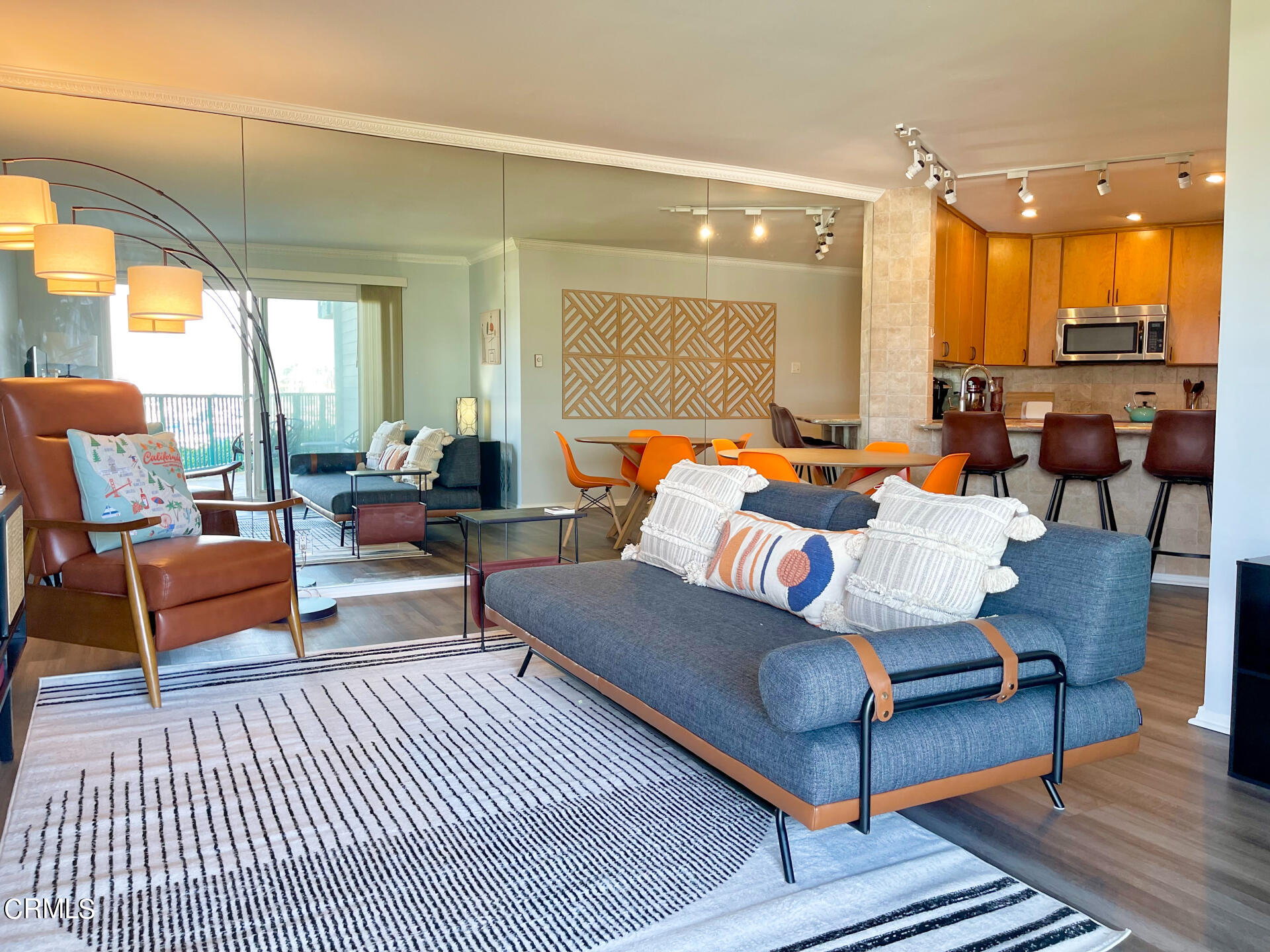 a living room with furniture a rug and a large window