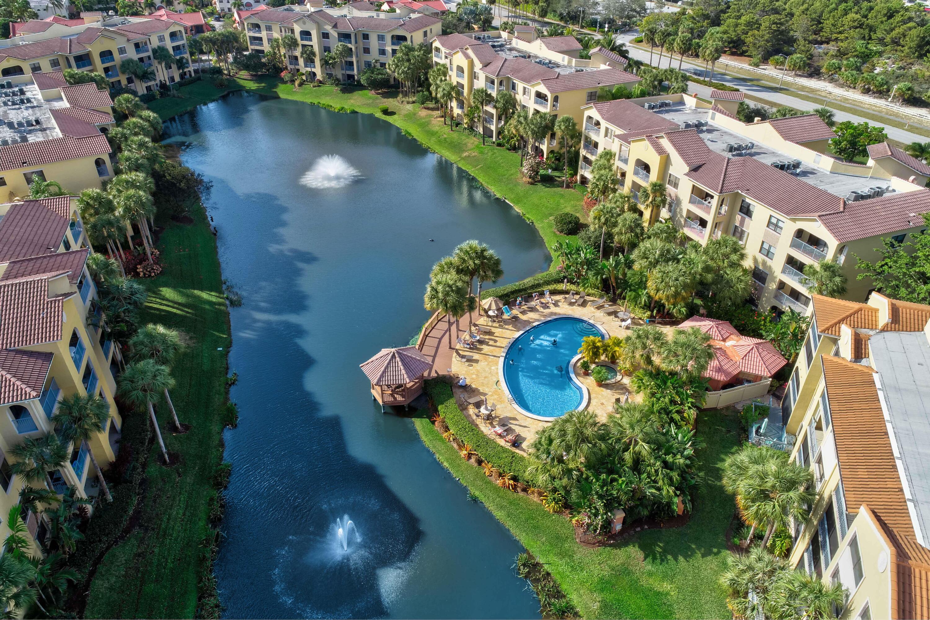 an aerial view of a house with a yard and lake view