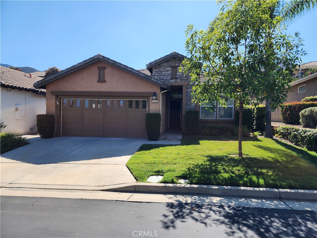 a front view of a house with a yard