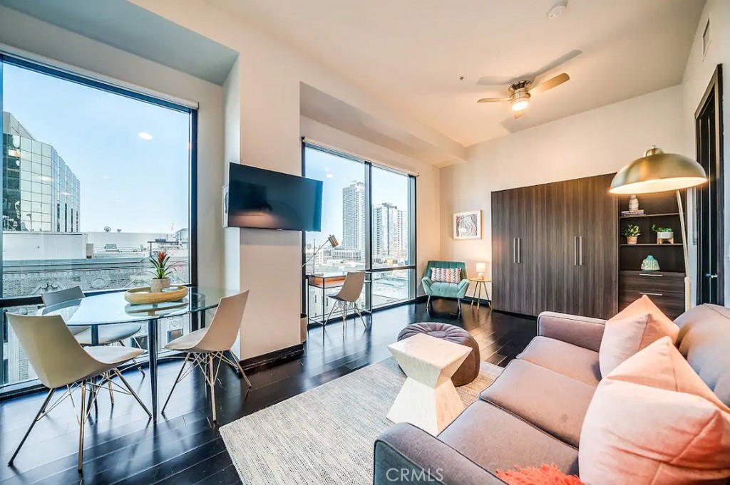 a living room with furniture and wooden floor