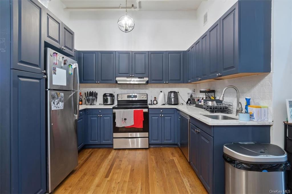 a kitchen with kitchen island a wooden cabinets and a sink