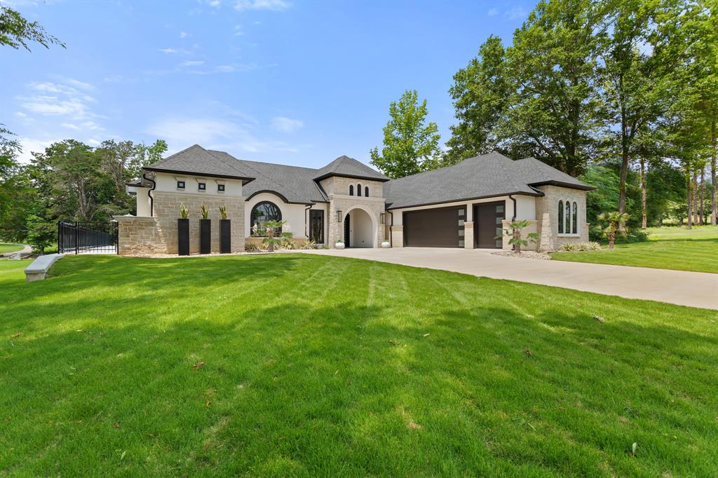 a front view of a house with a garden and yard