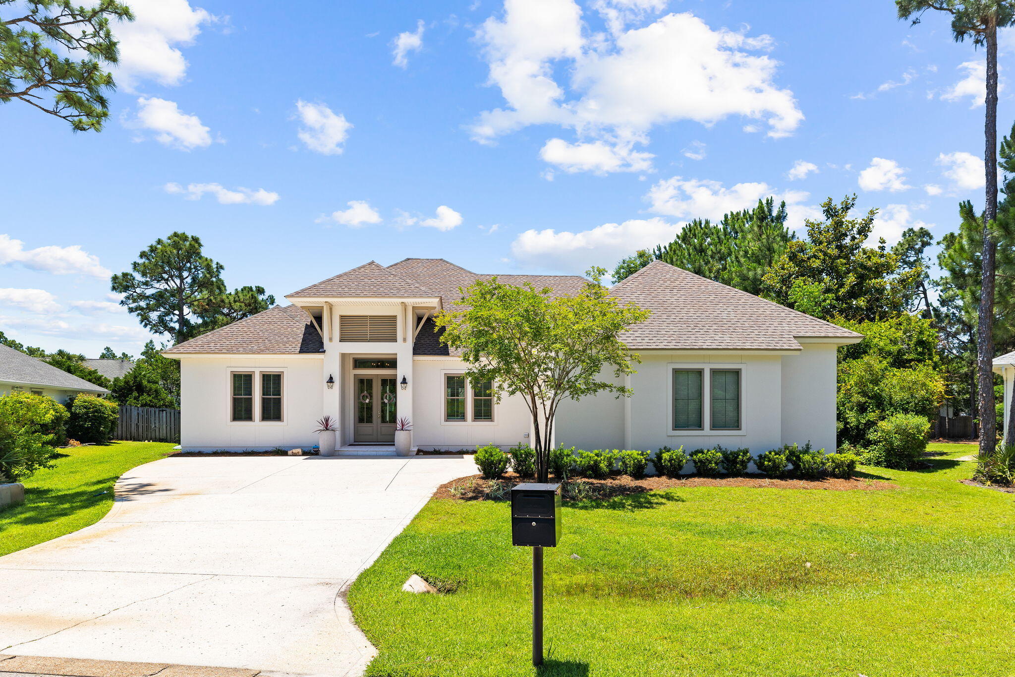 a front view of house with yard and green space