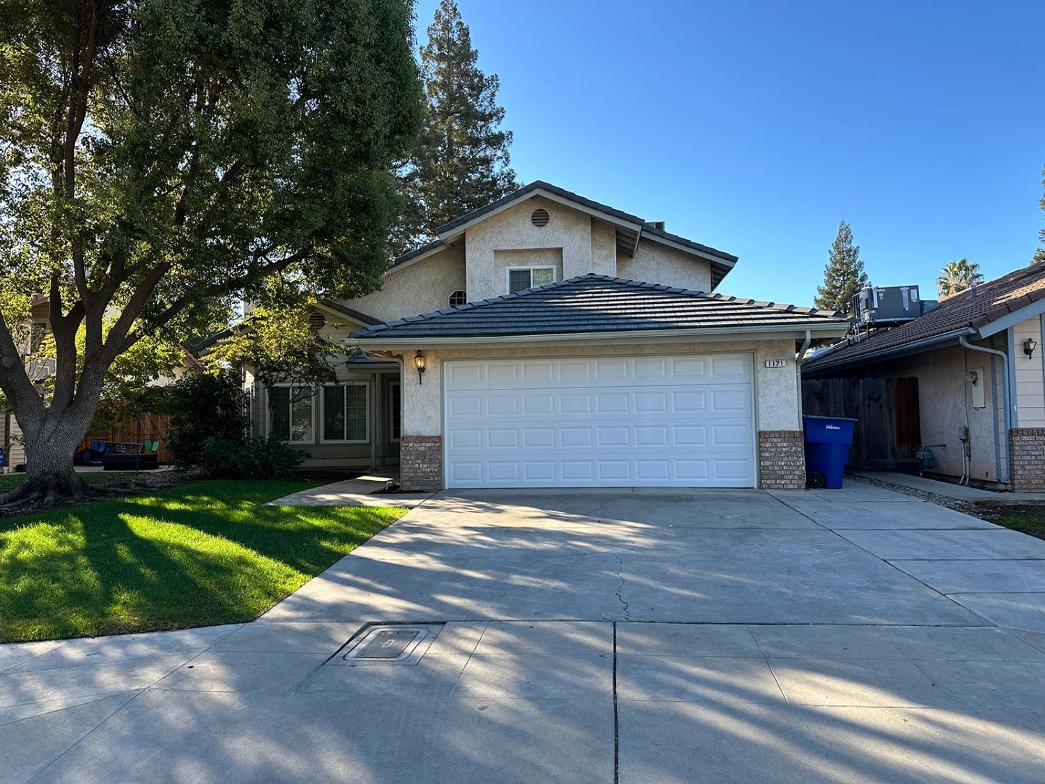 a view of a house with a yard and garage