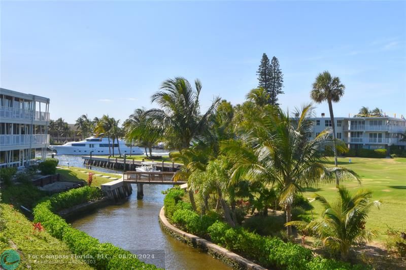 a view of a lake with a house and a yard