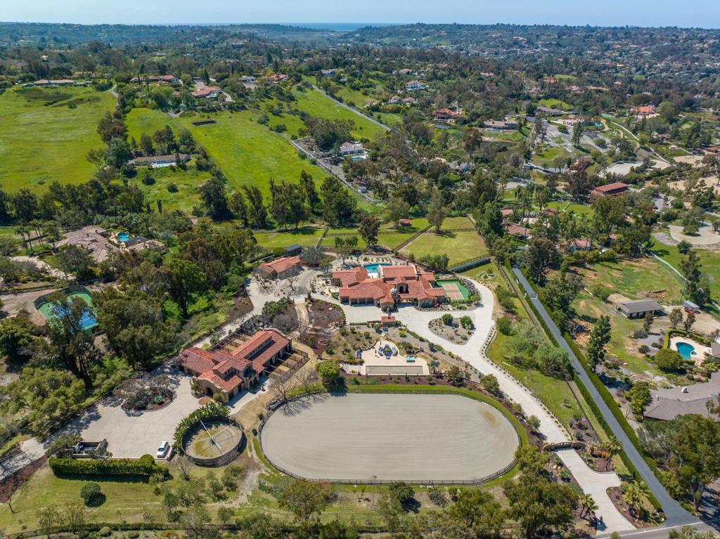 an aerial view of a house with garden space and lake view