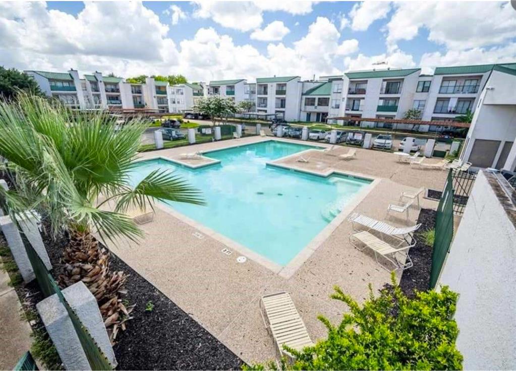 a view of a swimming pool with a lounge chairs