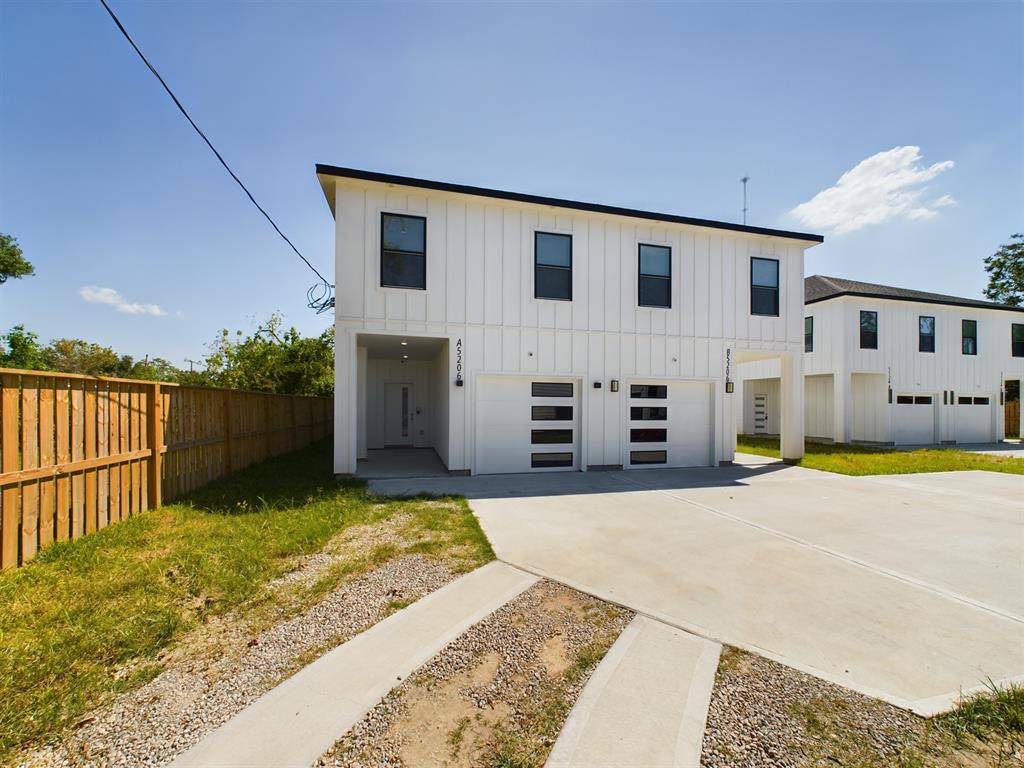 a view of a house with wooden fence