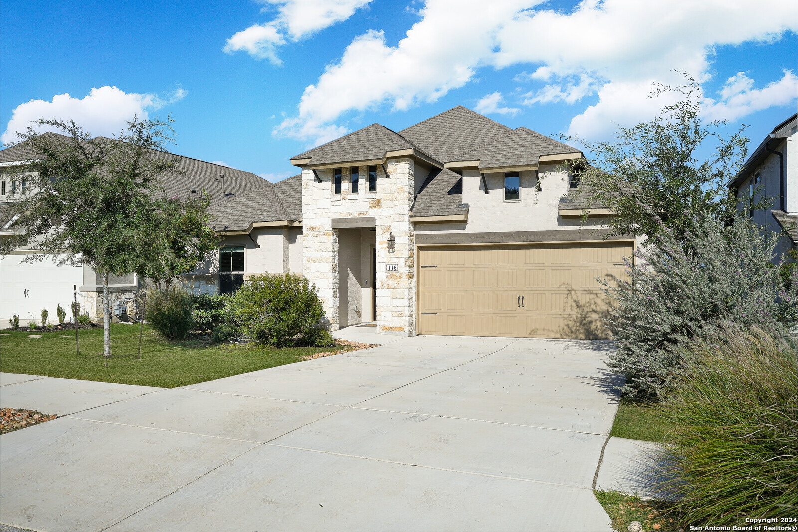 a front view of a house with a yard and garage