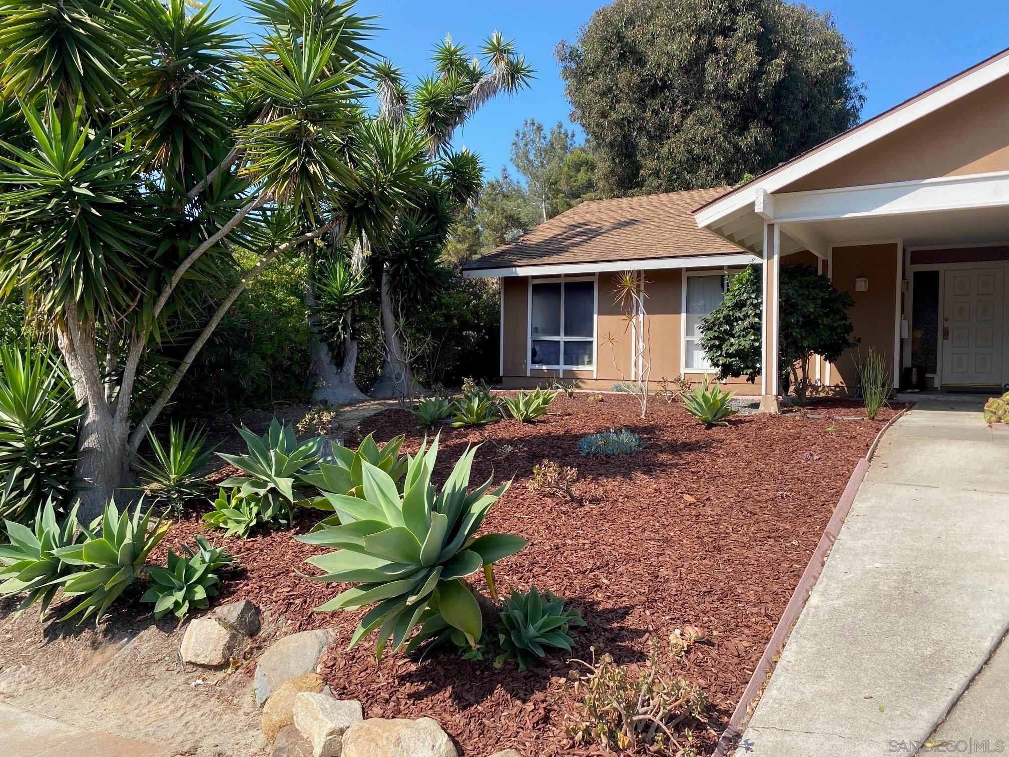 a front view of a house with garden and porch