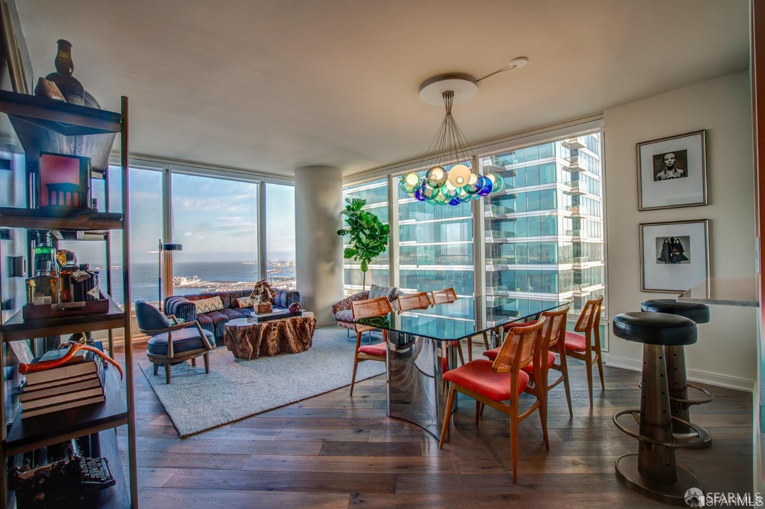 a living room with furniture a rug and a floor to ceiling window