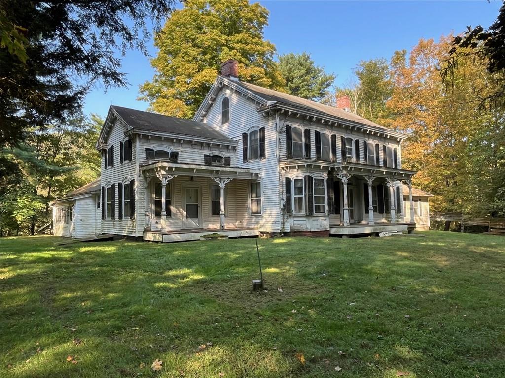 a front view of a house with a garden