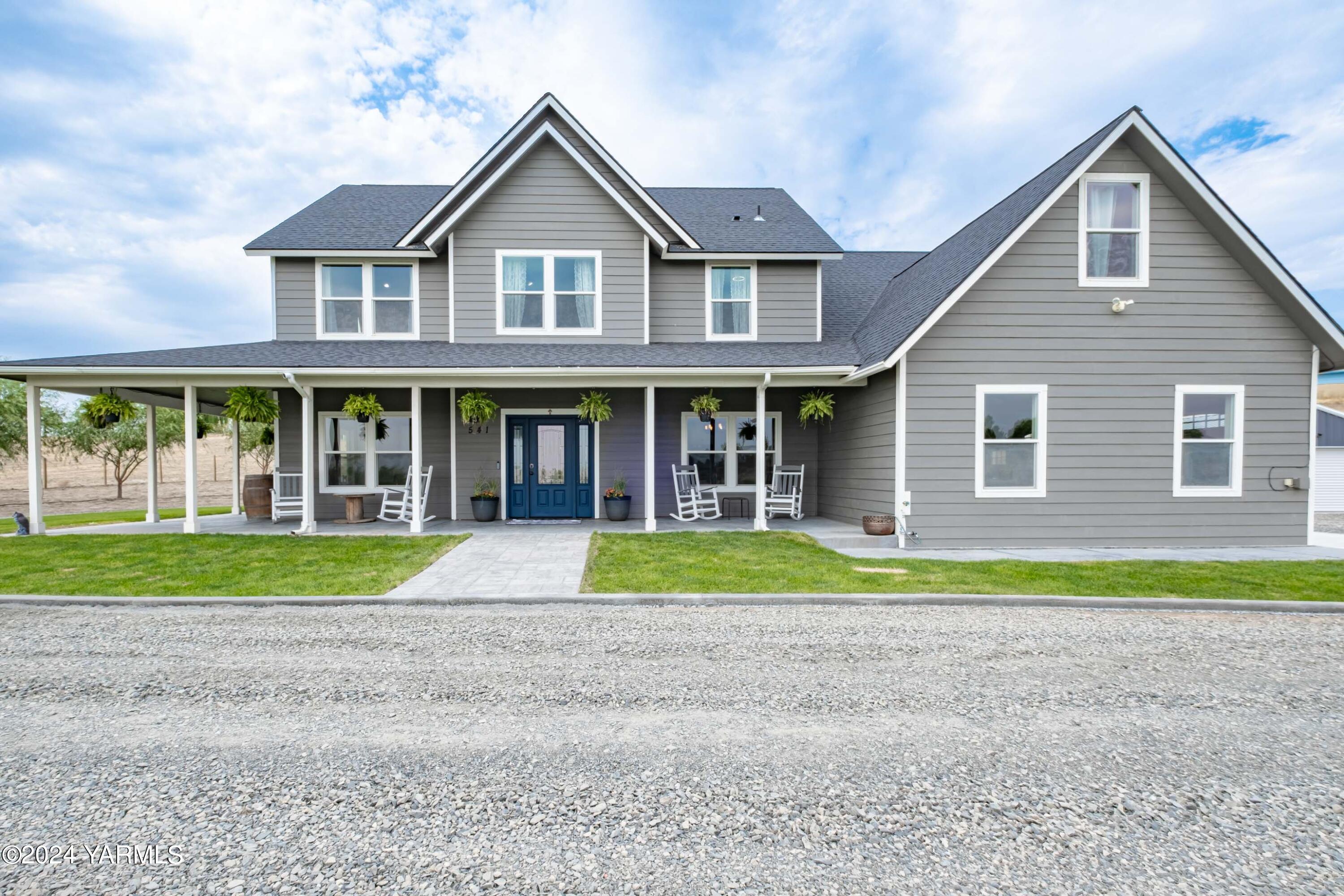 a big house with a big yard and large trees