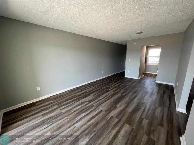 a view of an empty room and wooden floor