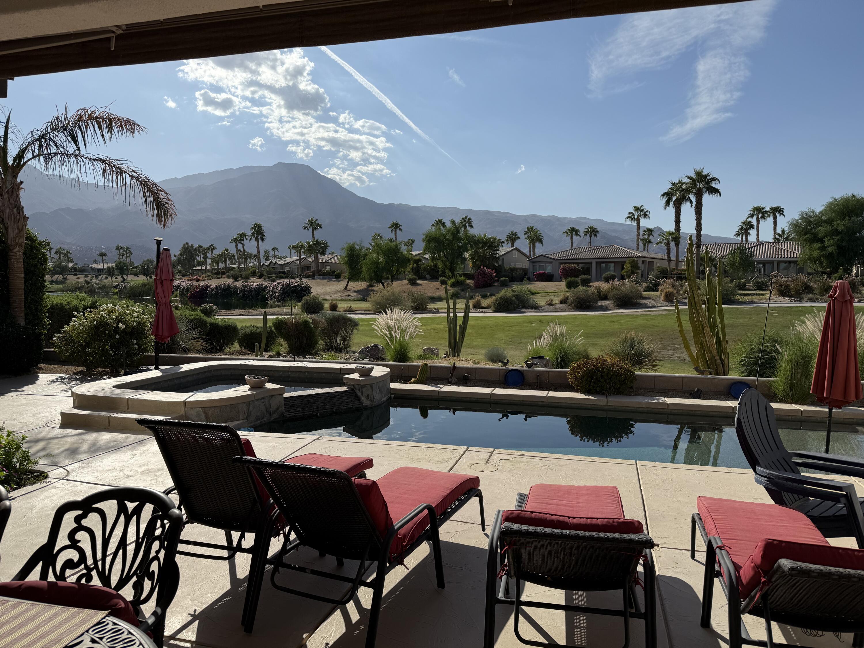 a view of a patio with swimming pool table and chairs