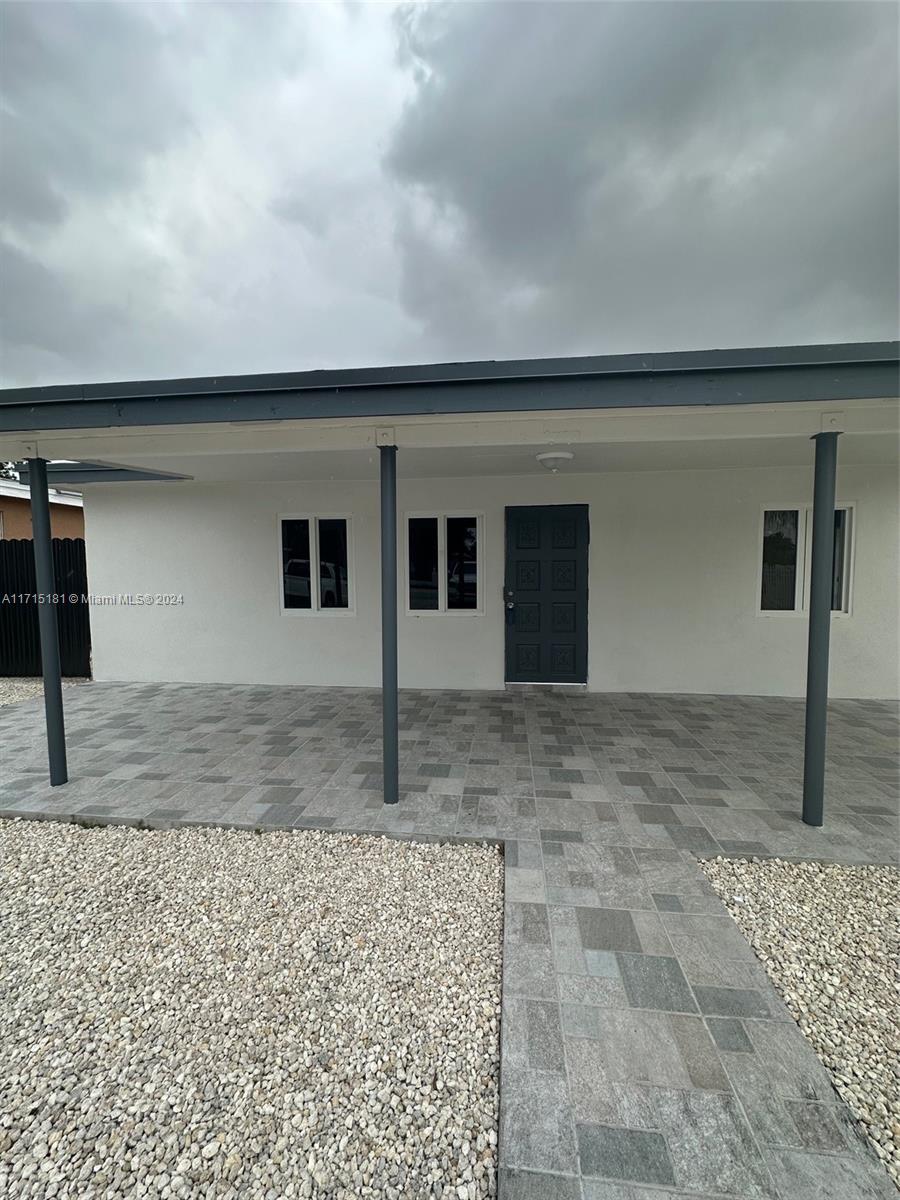 a view of a dry yard in front of a house