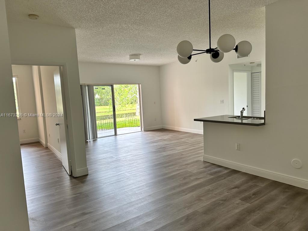 a view of a room with wooden floor and exposed radiator