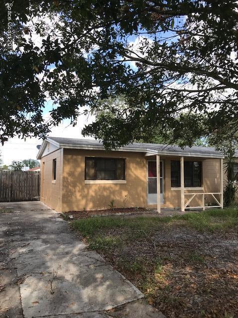 a house that has a tree in front of it