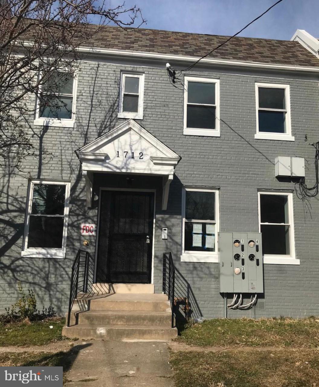 a front view of a house with parking space