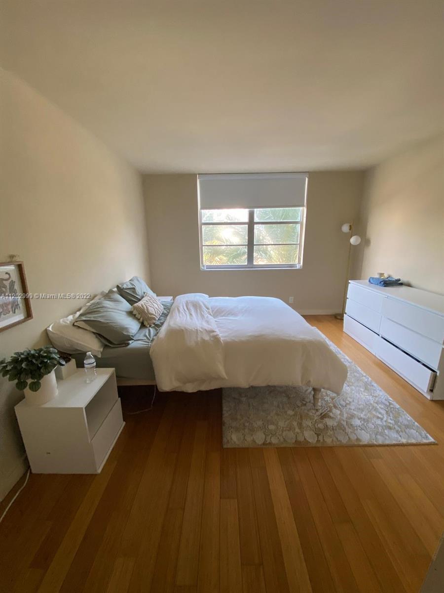 a bedroom with bed and window