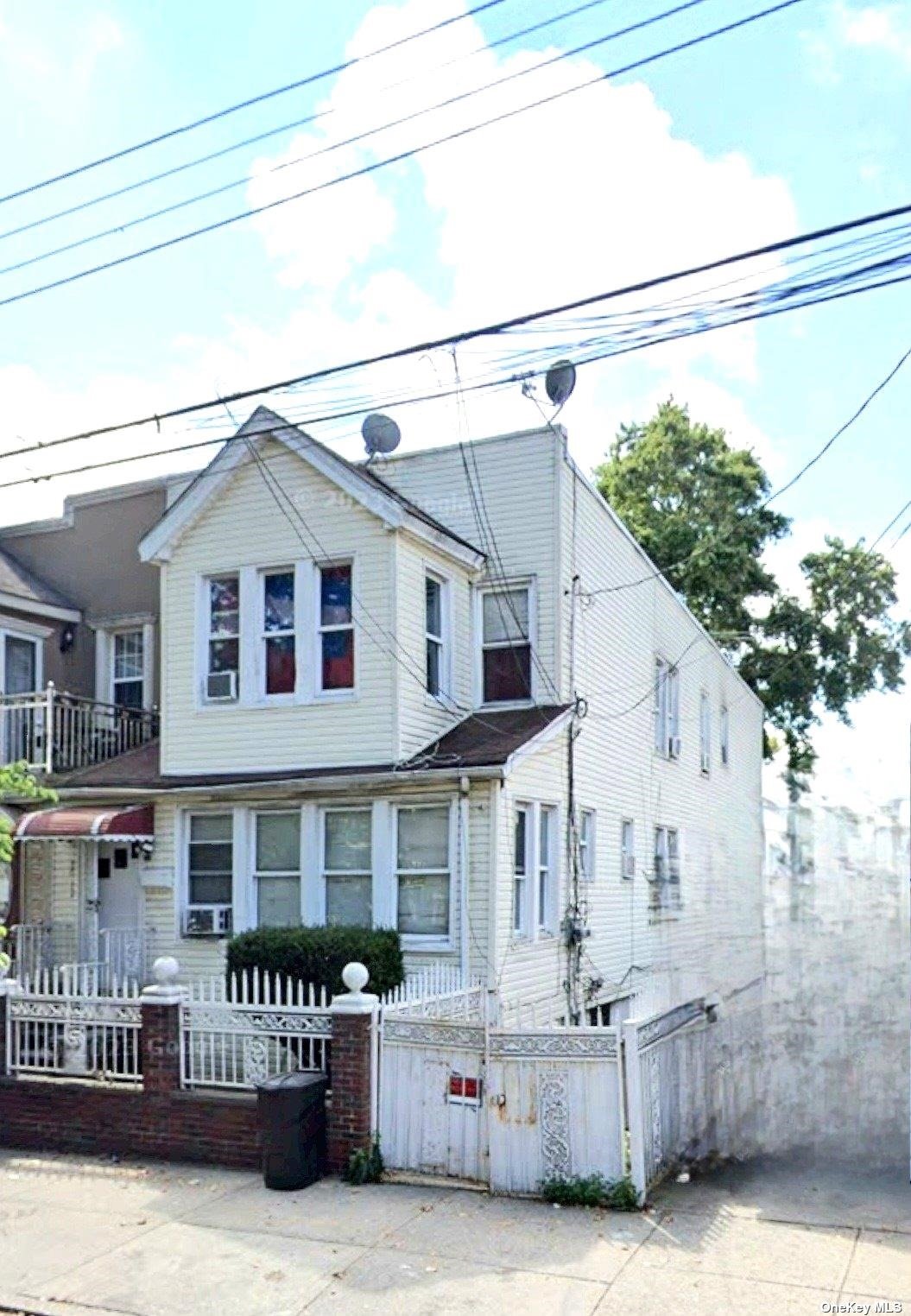 a view of a house with a wooden deck and furniture