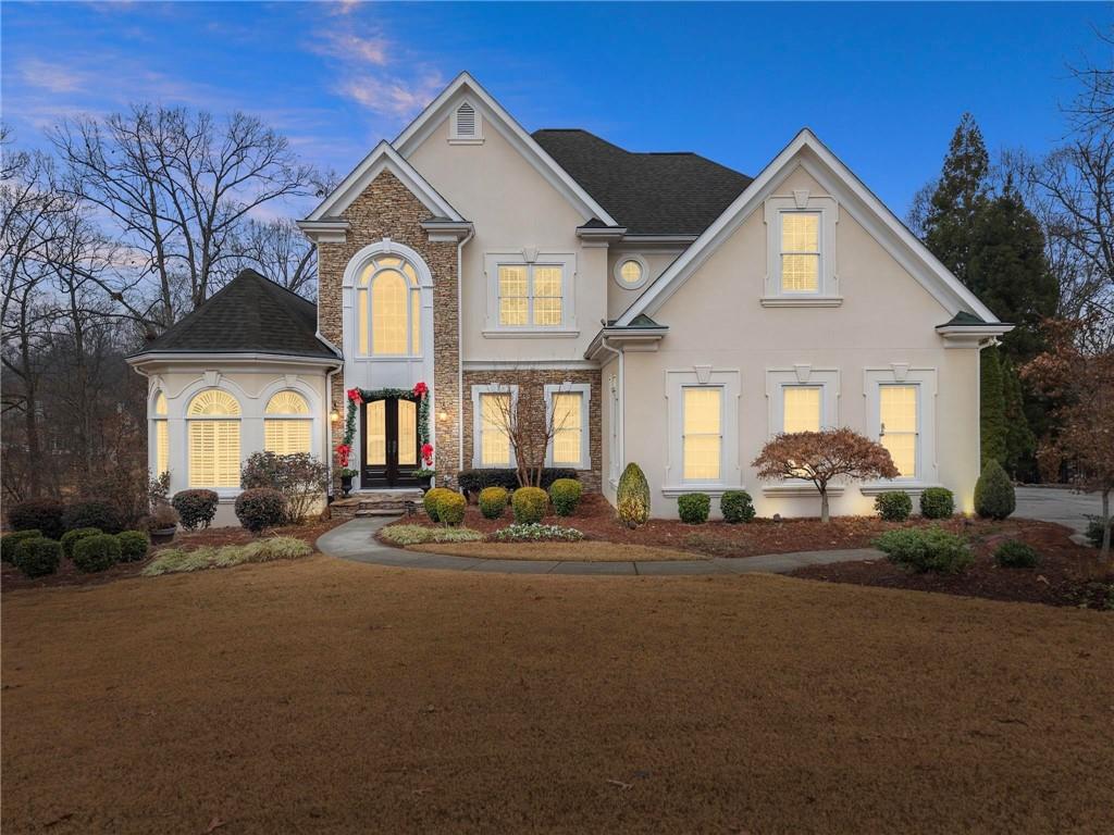 a front view of a house with a garden