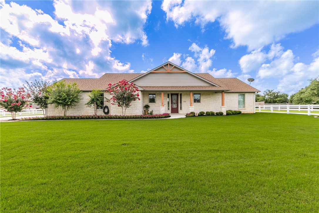 Ranch-style home featuring a front lawn